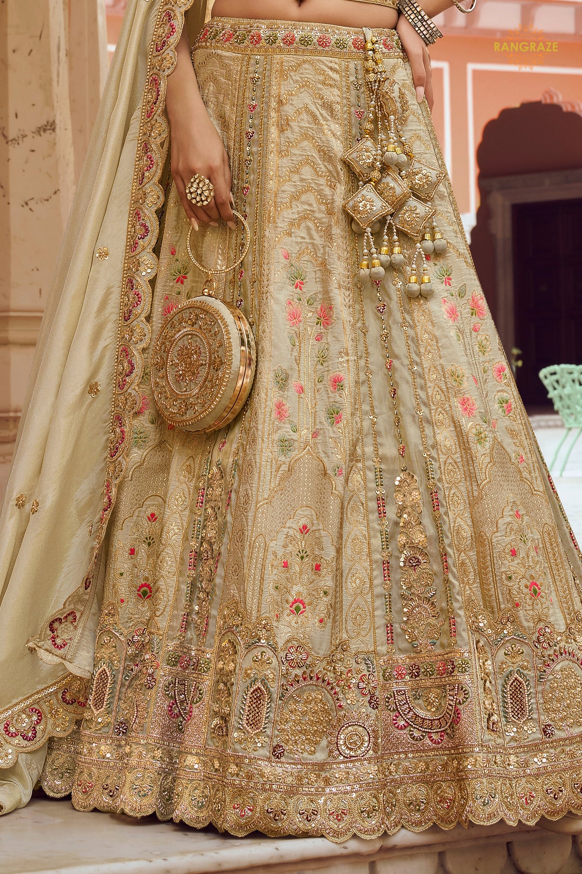 Cream Gold Heavy Work Banarasi Silk Lehenga With Clutch
